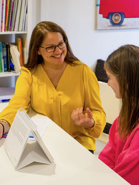 Sim reading with a young student during a one-on-one session